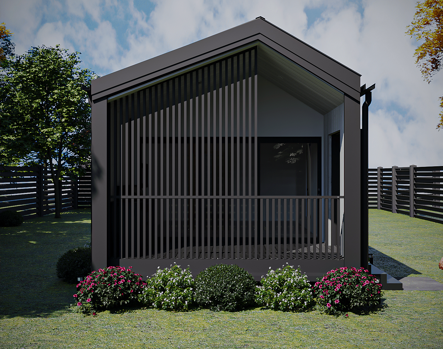 Front elevation of the 1-Bedroom gabled granny flat featuring vertical privacy louvers, covered front deck, and flowerbed landscaping (Lexicon Half light grey vertical cladding with dark Basalt roof and trim, captured under clear daylight).