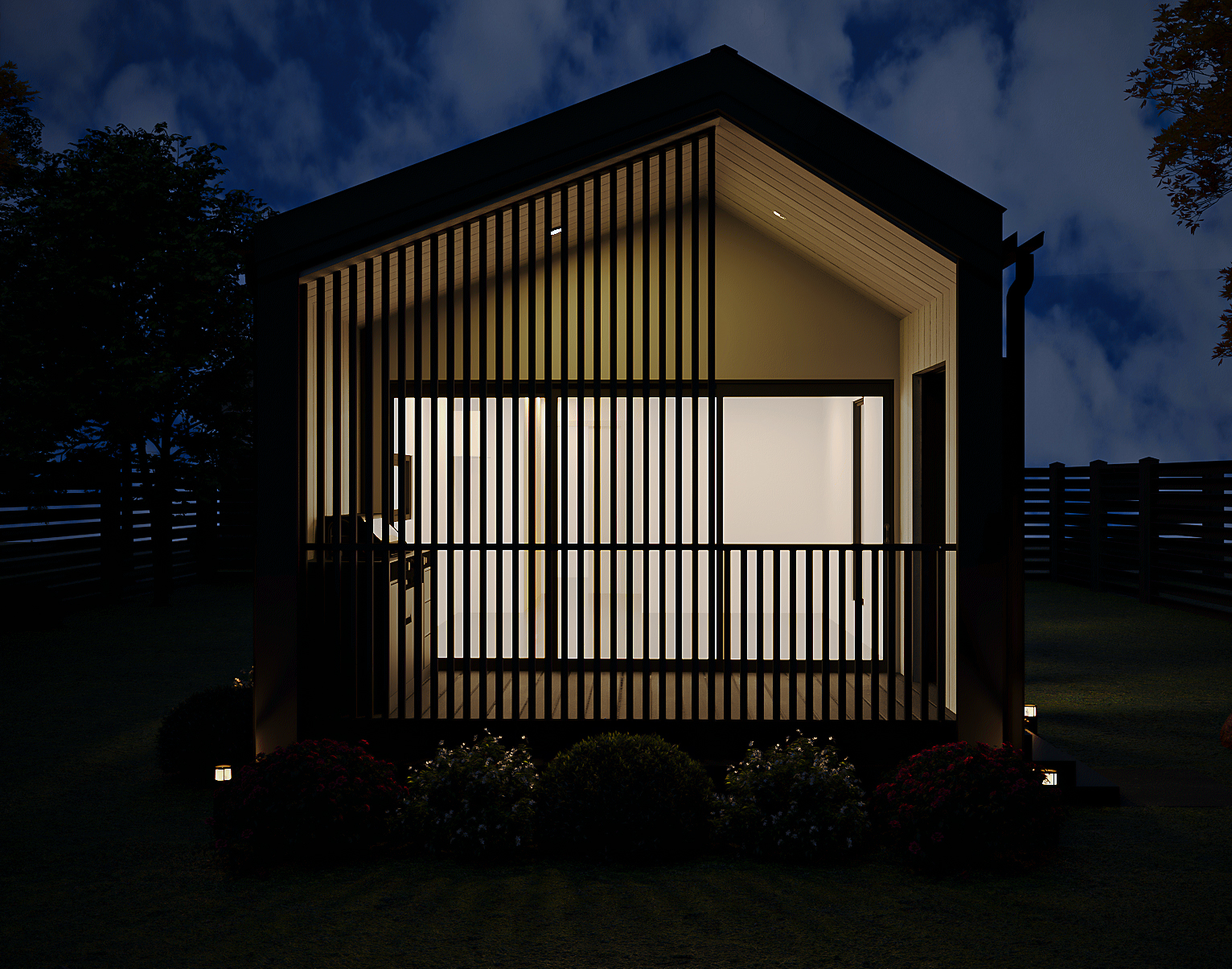 Atmospheric night render of the 1-Bedroom front facade with interior ambient light glowing through glass sliding doors and slatted privacy screen (Lexicon Half light grey vertical cladding with dark Basalt roof and trim, captured at twilight under warm architectural lighting).